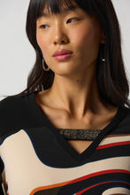 Load image into Gallery viewer, The Ronan Rhinestone V-Neck Top by Joseph Ribkoff is the perfect combination of elegance and contemporary style. This boxy top features a black silky knit and abstract patterned fabric in a unique mélange for a one-of-a-kind look. Finishing touches include a V-neckline with rhinestone trim and long straight sleeves with side slits. Create a unique style for any occasion. Color- Black, white, red, brown, blue, orange. Silky knit fabric. V-neckline. Long straight sleeves.