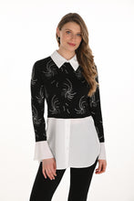 Load image into Gallery viewer, Woman wearing a black and white contrast tunic blouse with jewel embellishments and black pants against a white background.