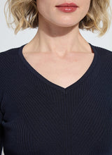 Load image into Gallery viewer, Close-up of a model wearing a dark blue ribbed V-neck top against a light background.