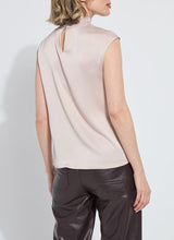 Load image into Gallery viewer, Woman wearing a light pink sleeveless blouse and brown leather pants against a white background.