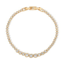 Load image into Gallery viewer, A graduated silhouette modernizes a classic tennis bracelet. Plated in 14-karat gold and lined with cubic zirconia, this sparkling piece of jewelry is an eye catcher and compliment maker. Our Alexandria Graduated Bracelet matches perfectly with our Alexandria Graduated Tennis Necklace. Color- Gold and Clear. 7 inch. 14 kt gold over brass.