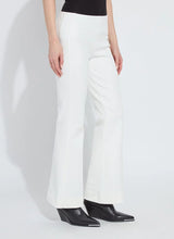 Load image into Gallery viewer, Model wearing white pants and black boots against a white background.