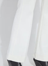 Load image into Gallery viewer, Close-up of white pants and black boots against a white background.