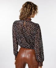 Load image into Gallery viewer, This brown, smocked long sleeve blouse, featuring swirling circles known as "Animal Steps," is a fashionable piece that can be dressed up or down depending on the occasion. Its unique design offers a chic and stylish look. Color-Brown, black, brown. Button back closure. Smocked neck and sleeves. Slightly sheer. Suggest wearing a black bra or black cami underneath.