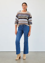 Load image into Gallery viewer, Woman wearing a multi blue and sparkle sweater, blue jeans and tan boots against a neutral background.