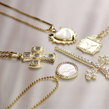 Load image into Gallery viewer, Gold necklaces with various pendants on a light background