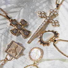 Load image into Gallery viewer, Gold necklaces with various pendants on a textured white surface.