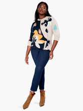Load image into Gallery viewer, This sleek design combines patterned and natural elements to create an attractive, understated look. The intarsia pattern is seasonally versatile, while the functional side tie adds a personalized touch. Crafted with eco-friendly materials, this pullover is designed to be part of a sustainable wardrobe. Color-Indigo multi- Navy, yellow gold, pinks, turquoise, white and sand. Pullover sweater. Intarsia knit. Midweight. Easy fit. Round neck. Tie front. Sits at hip.