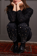 Load image into Gallery viewer, Elevate your style with glamorous gemstone accents on the striking black Audrey Pull-On Slim Jean. Crafted for the contemporary woman, these jeans boast a smooth pull-on design, free from zippers or buttons, for a seamless and flattering silhouette. The slim-leg cut accentuates your figure, offering a flexible and chic option for your clothing collection