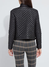 Load image into Gallery viewer, Model wearing a black quilted jacket and plaid pants against a white background.