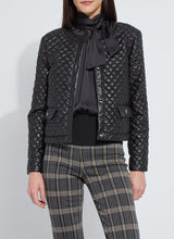 Load image into Gallery viewer, Model wearing a black quilted jacket over a black blouse and plaid pants against a white background.