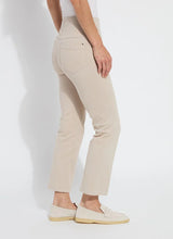 Load image into Gallery viewer, Discover the perfect fit for women with a shorter stature with our Ankle Denim Baby Bootcut - a stylish pant featuring a 27-inch length and slight leg flare. Our pants are made from 4-way stretch Knit Denim and offer a concealed patented waistband, back patch pockets with metal grommets and anatomical seaming for a flattering and comfortable fit. The Ankle Denim Baby Bootcut jean sculpts the body with its precise hip and thigh coverage, leading to an elegant open bootcut leg.