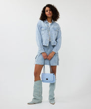 Load image into Gallery viewer, The Esqualo Denim Bag is a stylish and versatile accessory. It features a distressed denim design with black steel detailing, a twist-lock closure, and a zippered pocket on the back. Perfect for adding a chic touch to your outfit.