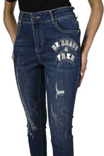 Load image into Gallery viewer, The Frank Lyman jean, also known as the "Brooklyn Be Brave & Free Sparkle Jean," is a dazzling addition to any wardrobe. These jeans feature sparkling details with phrases like "Be Brave, Be Free" shining on one side, and the Eiffel Tower along with the word "Paris" on both sides. Made from a blend of cotton, polyester, rayon, and elastane, they offer stretchable comfort and a stylish edge.