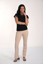 Load image into Gallery viewer, Woman wearing a black top, beige pants and black sandals on a white background.