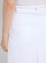 Load image into Gallery viewer, Effortlessly stylish, the Bellamy Denim Skirt is designed with an on-trend A-line flare silhouette, combining comfort and chic fashion. This skirt features faux front pockets, belt loops with rivet details, back patch pockets, and a classic V insert for added flair. Crafted from premium 4-way stretch Knit Denim, the Bellamy offers a below-knee length and unlined design with a concealed patented waistband for a sleek fit.