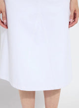 Load image into Gallery viewer, Effortlessly stylish, the Bellamy Denim Skirt is designed with an on-trend A-line flare silhouette, combining comfort and chic fashion. This skirt features faux front pockets, belt loops with rivet details, back patch pockets, and a classic V insert for added flair. Crafted from premium 4-way stretch Knit Denim, the Bellamy offers a below-knee length and unlined design with a concealed patented waistband for a sleek fit.