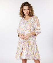 Load image into Gallery viewer, Gorgeous eye-catching spring/summer colors just pop on this stunning dress by EsQualo. With its feminine design, you will feel so pretty when you wear this beauty to luncheons with friends, garden/pool parties or evening events. Colors- Shades of greens, purples, orange, touch of brown on a white background. Whimsical floral print. V-Neck. Drop waist. Three-quarter sleeves. Fabric -100% Viscose.