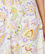 Load image into Gallery viewer, Gorgeous eye-catching spring/summer colors just pop on this stunning skirt by EsQualo. With its feminine design, you will feel so pretty when you wear this beauty to luncheons with friends, garden/pool parties or evening events. Colors- Shades of greens, purples, orange, touch of brown on a white background. Whimsical floral print. Fully lined. Side zipper closure. Back elastic waist. Fabric -100% Viscose.