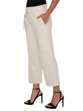 Load image into Gallery viewer, Model wearing tan wide leg crop pants with belt, black top and black heels against a white background.