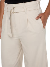 Load image into Gallery viewer, Model wearing tan wide leg crop pants with belt, black top and black heels against a white background.