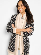 Load image into Gallery viewer, Woman wearing a neutral and black long jacket over a neutral riding sweater against a white background.
