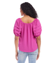 Load image into Gallery viewer, Add a pop of vibrant color to your wardrobe with the Karen Kane Becca Berry Pleat Sleeve Top. Featuring pleated tiers on the sleeves, a shirred neckline, and a flattering shirttail hem, this peasant-style top offers a charmingly feminine aesthetic. Crafted from 100% polyester heavy moss crepe, it’s lightweight and perfect for both casual and dressy occasions. Designed for comfort and style, this top is a versatile must-have for any season.