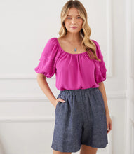 Load image into Gallery viewer, Add a pop of vibrant color to your wardrobe with the Karen Kane Becca Berry Pleat Sleeve Top. Featuring pleated tiers on the sleeves, a shirred neckline, and a flattering shirttail hem, this peasant-style top offers a charmingly feminine aesthetic. Crafted from 100% polyester heavy moss crepe, it’s lightweight and perfect for both casual and dressy occasions. Designed for comfort and style, this top is a versatile must-have for any season.