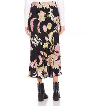Load image into Gallery viewer, Discover effortless elegance with our bias-cut skirt. This midi skirt showcases a striking pink floral print on a sleek black background, crafted from high-quality crepe material. Its versatility offers endless styling possibilities.