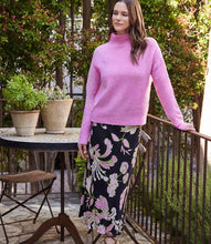 Load image into Gallery viewer, Discover effortless elegance with our bias-cut skirt. This midi skirt showcases a striking pink floral print on a sleek black background, crafted from high-quality crepe material. Its versatility offers endless styling possibilities.