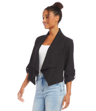 Load image into Gallery viewer, Find the perfect balance between both fashion and comfort with this eco-friendly essential. Its drape collar exudes a sense of effortless sophistication, crafting a flattering silhouette to suit all body types. Color - Black. Draped collar. Roll-up sleeves with button tabs. Smocked back. Hi-low hem.