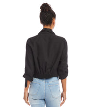 Load image into Gallery viewer, Find the perfect balance between both fashion and comfort with this eco-friendly essential. Its drape collar exudes a sense of effortless sophistication, crafting a flattering silhouette to suit all body types. Color - Black. Draped collar. Roll-up sleeves with button tabs. Smocked back. Hi-low hem.