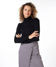 Load image into Gallery viewer, Experience a stylish look with our Bara sweater. Crafted with a plush fabric blend for maximum comfort, this turtleneck is further enhanced with gold button shoulder accents for a luxurious, fashionable finish. Color- Black. Turtleneck. Gold button detailing on shoulder. Cuffs.