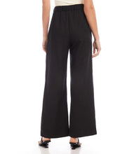 Load image into Gallery viewer, Update your wardrobe with these versatile pants that combine fashion and functionality. The high-waisted design and pleats not only enhance your silhouette, but also offer a contemporary and flattering fit - perfect for any occasion. Color - Black. Full Length. Wide leg. Lined. Front Pleat. Inseam-29 1/2 inches.