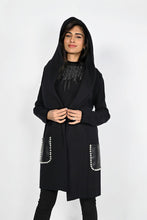 Load image into Gallery viewer, A stunningly unique piece, the Belen hooded cardigan adds a sophisticated finish to any look. Crafted with faux leather pockets and adorned with white pearl embellishments, it's guaranteed to turn heads. Color- Black. Hood. Pearl embellishments. Faux leather pockets. Fabric -50% Rayon, 28% Polyester. 22% Nylon.