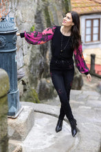 Load image into Gallery viewer, This Frank Lyman garment features a semi-sheer sleeve design in a bold magenta hue, adorned with an intricate floral pattern. Tailored with a stretchy fabric to provide a relaxed fit, the McKenna top pairs perfectly with jeans or trousers. Pair with our Bettany Black and Magenta Painted Foral Denim Jean - Frank Lyman 233886U for a perfect look. Color - Magenta, bright coral, pink and black. Billowy sleeves. Semi sheer sleeves. No pockets. No zipper.