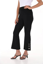Load image into Gallery viewer, The black above-the-ankle pants are a versatile wardrobe staple, offering endless possibilities for effortless style. The silver rivet embellishments elevate the look of a basic black pant and create an eye-catching silhouette. With their timeless elegance and flattering fit, they seamlessly pair with any top or shoe, making them a go-to choice for both casual and formal occasions.