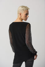 Load image into Gallery viewer, This luxurious tunic is crafted from a silky knit fabric, with mesh puff sleeves for a touch of drama. The asymmetrical design is flattering and feminine, while the beading detail adds a touch of glamour. Color - Black. Silky knit with mesh. Beading on sleeves. Boat neckline. Puff sleeves. Asymmetrical hem. Unlined.