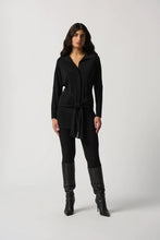 Load image into Gallery viewer, This exquisite tunic is crafted from a luxuriously silky knit fabric, complete with a shirt collar and a sash at the hips that creates a flattering fit and flare silhouette. An ideal addition to any wardrobe, this stunning piece pairs perfectly with pants or jeans. Color- Black. Shirt collar. Sash at the hips. Button down. Unlined.