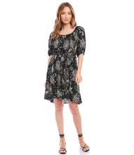 Load image into Gallery viewer, A charming scarf print puts a bohemian focus on this summer-ready dress. This statement-making dress features peasant sleeves, a tiered hem and flattering cinched waist and matching belt. Colors- Black and white. Short puff sleeve. Side pockets. Self-tie belt. Tiered hem. Cinched waist.