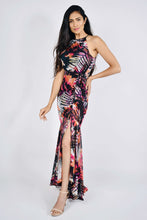 Load image into Gallery viewer, Stunning maxi dress by Frank Lyman, in tropical leaf print chiffon. This striking dress is a very flattering design, with cut away shoulders, ruffle hem and side split which can be adjusted. The side split can be shortened or lengthened with the tie, creating a more ruched effect as the split goes higher to show a little more leg.