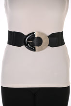Load image into Gallery viewer, A wide black waist belt with a large, bold gold-toned metal and black oval buckle, shown worn over white top and black pants.