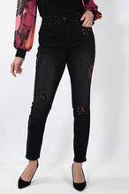 Load image into Gallery viewer, These black straight leg jeans crafted from exceptional denim feature eye-catching hand-painted motifs of bright magenta flowers, which are further accented with sequins and rhinestones for a dazzling finish. Make a bold style statement and stand out from the crowd in these extraordinary jeans. Color- Black and magenta. Slim leg design. Painted floral designs with sequin and rhinestones. Floral designs on front side only. Five functional pockets. Zipper and button closure.