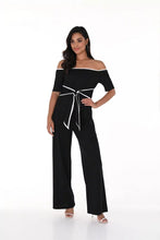Load image into Gallery viewer, This jumpsuit effortlessly blends refined elegance with contemporary style, showcasing a sleek off-shoulder design in black with off-white contrast stitching. The belted waist accentuates the silhouette, making it a versatile and fashionable choice for any event.