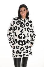 Load image into Gallery viewer, Woman wearing a white coat with black leopard print pattern and black pants against a white background.