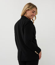Load image into Gallery viewer, Woman wearing a black blazer with gold buttons and black pants against a white background.