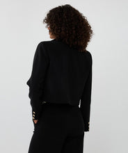 Load image into Gallery viewer, Woman wearing a short black blazer and black pants against a white background.