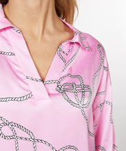 Load image into Gallery viewer, This perfect pink blouse in a satin feel with polo collar and "rope" print is striking in design. A beautiful top to dress up or wear casually, this blouse will definitely receive compliments. Color- Pink, white, black. Long sleeves. One button sleeve closure. Wide fit. Polo collar design. Rope print. Pullover. Satin feel.