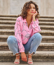 Load image into Gallery viewer, This perfect pink blouse in a satin feel with polo collar and "rope" print is striking in design. A beautiful top to dress up or wear casually, this blouse will definitely receive compliments. Color- Pink, white, black. Long sleeves. One button sleeve closure. Wide fit. Polo collar design. Rope print. Pullover. Satin feel.