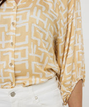 Load image into Gallery viewer, Brighten up your wardrobe with this lightweight shimmer blouse from EsQualo. The Eta Blouse features relaxed raglan three quarter sleeves, v-neckline, and a straight hem for an easy, untucked fit. Its soft, metallic sheen adds a touch of radiance, making it just as perfect for laid-back brunches as it is for polished workwear looks. Effortlessly stylish and breezy, it layers beautifully under blazers or shines on its own with denim and heels.